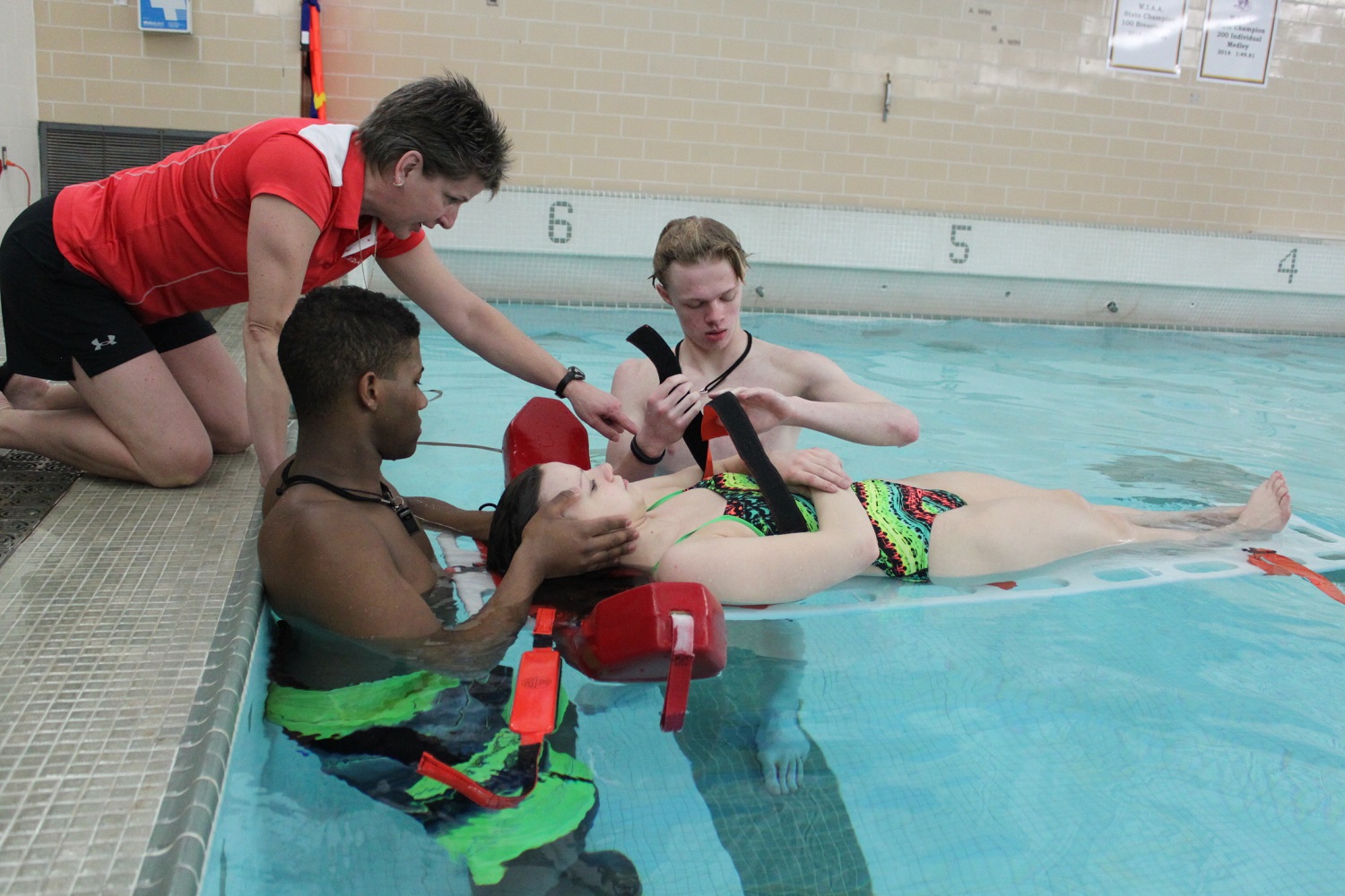 Gym Class Heroes: Kari Winkler, PE department chair at the Eau Claire Area School District in Wisconsin, instructs a lifeguard course at Memorial High School. Students earn PE credit for taking the course.