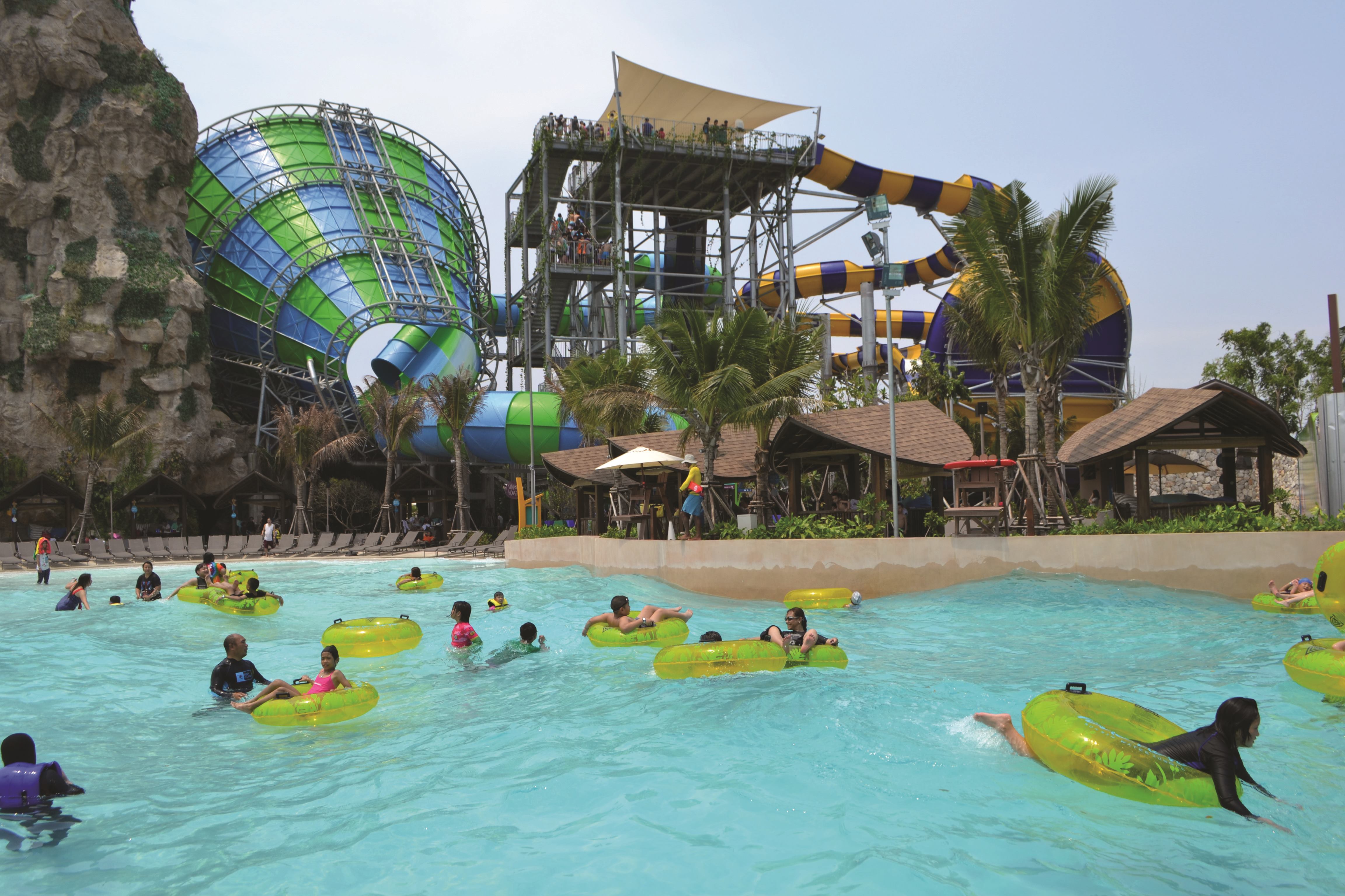 Coconut Beach features a 17,000-square-foot wave pool and sandy area highlighted by islands. A nearby stage allows swimmers to enjoy performances.