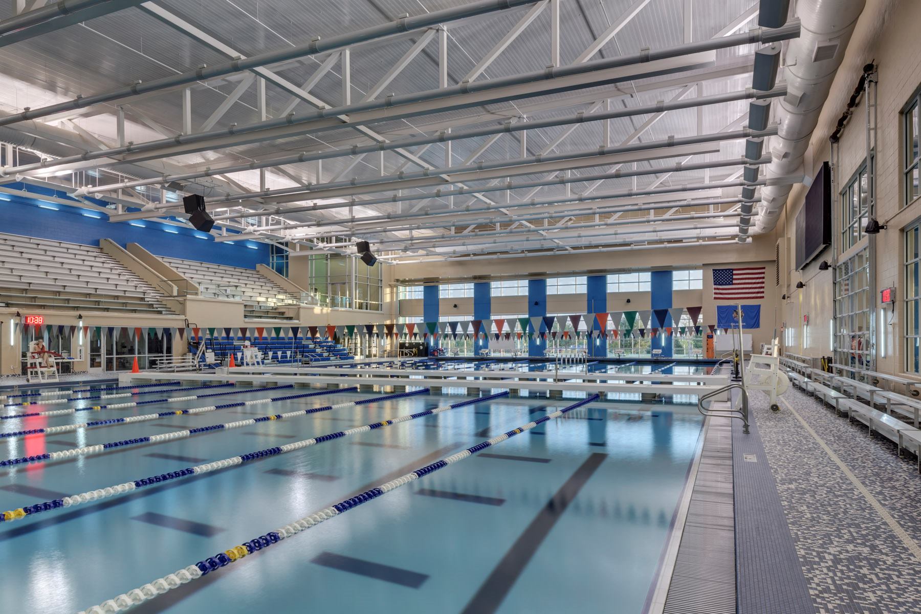 The design and materials incorporated in the aquatic spaces are meant to unify the wet areas while distinguishing them from the dry. Inset vertical bands, seen in the floor-to-ceiling windows in back, accentuate the height of the rooms. Fully tiled decks were used in the leisure and competitive spaces. The competition pool is used by several schools, so the designers took great care to choose a neutral palette that wouldn’t match any particular team’s colors.
