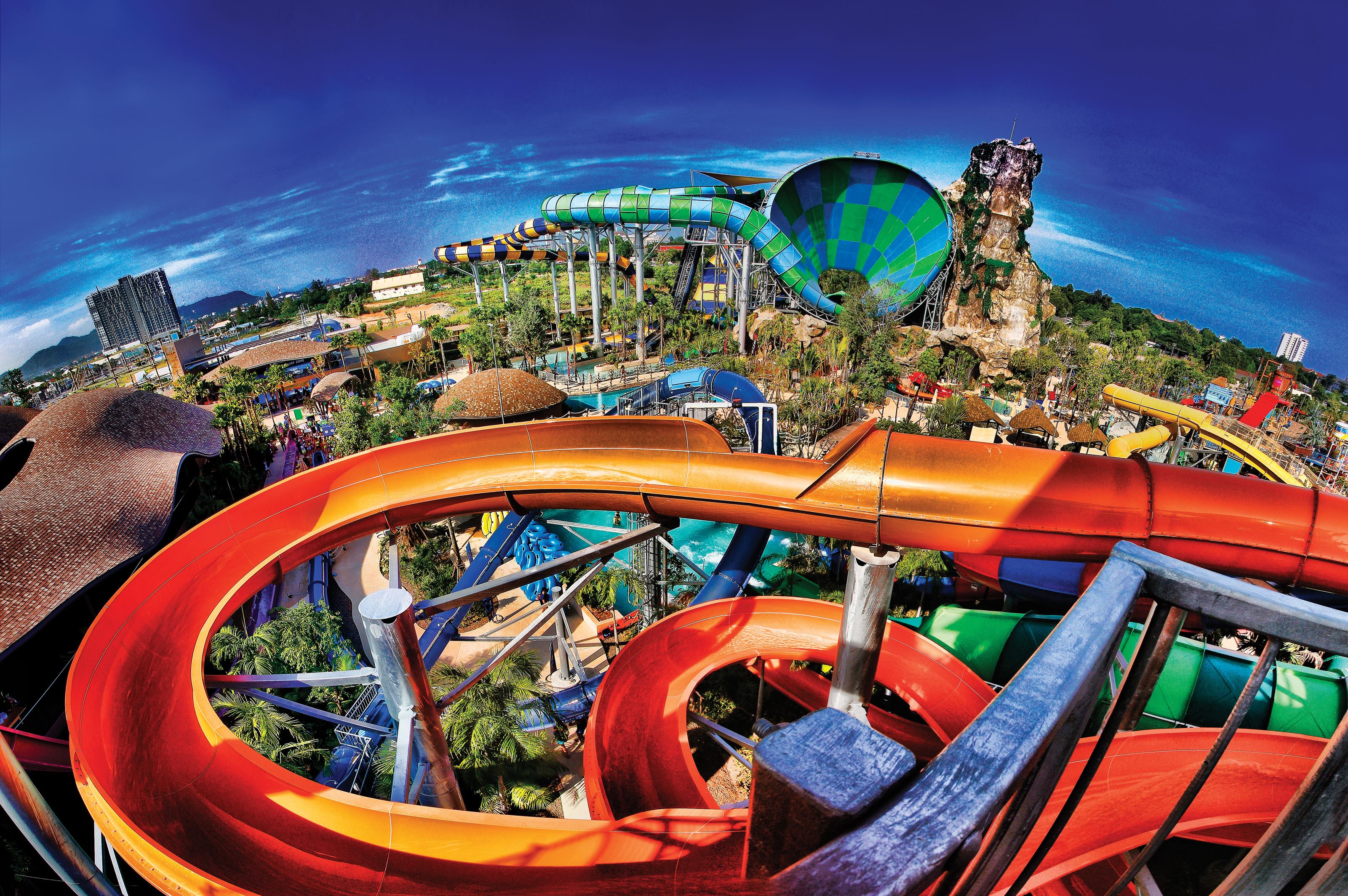 The blue and green funnel in the background is Abyss, said to be the largest water slide in Thailand. It lifts up to six people 91 feet, then spins and drops them into the funnel at more than 28 miles per hour.