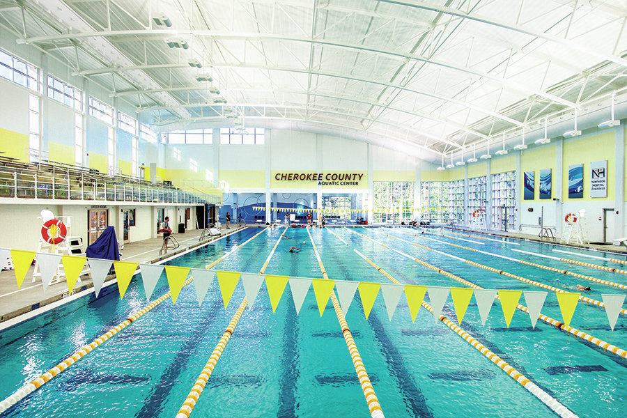 The 46,298-square-foot enclosure was built before the pools so contractors could work in dry conditions. As much as possible, the pools were elevated above the large amount of subsurface rock to minimize the need for extraction. A "fast" 10-lane, 50-meter pool with a movable bulkhead was created using water-saving technology and innovative gutter and filtration systems. The designers placed support columns between the pool deck and another four-lane, 25-yard therapy/warm-up pool, to create separate areas while allowing easy access.