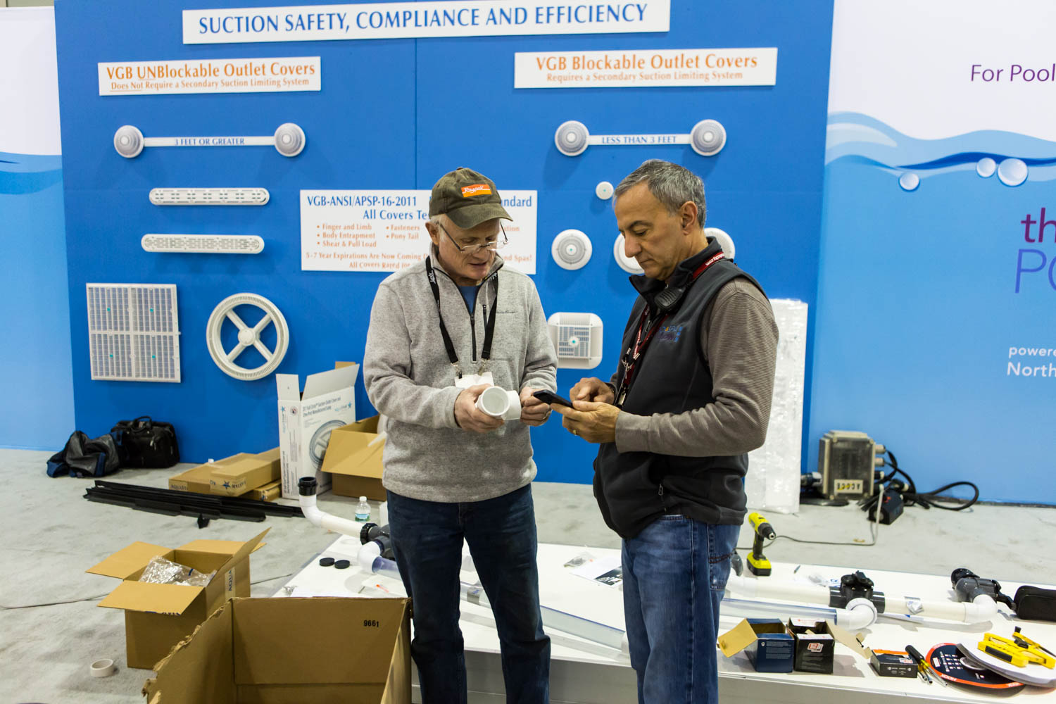 Caniglia, right, and a member of the Northeast Spa and Pool Association setting up at The Pool & Spa Show.