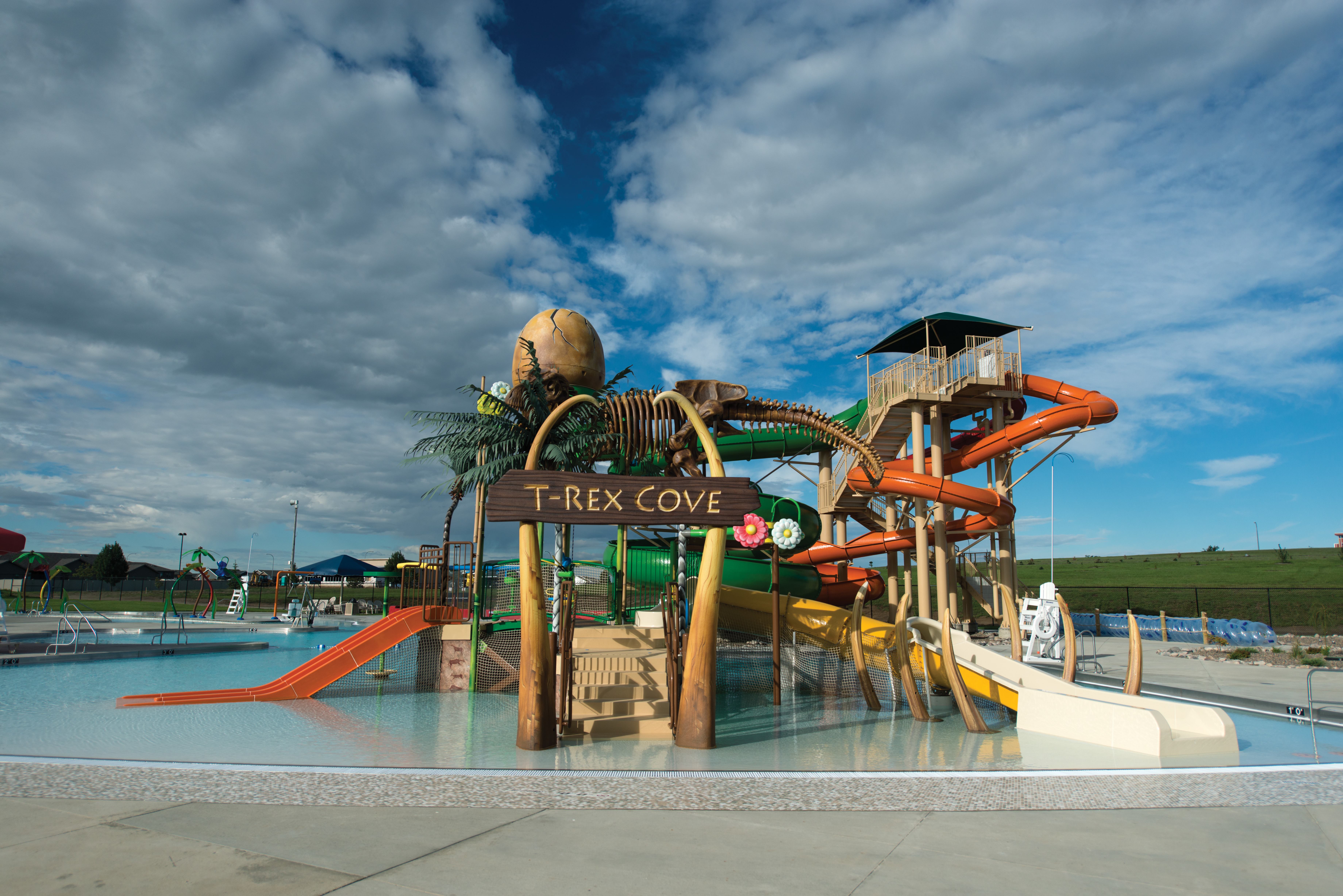 Families enjoy the 250-foot lazy river with vertical and flush water sprays; slides and underwater benches draw teens; and the T-Rex Cove play structure entertains smaller children. A separate zero-depth-entry pool provides little ones with another safe environment. The tower stands 33 feet high and features speed-, body- and flume slides.