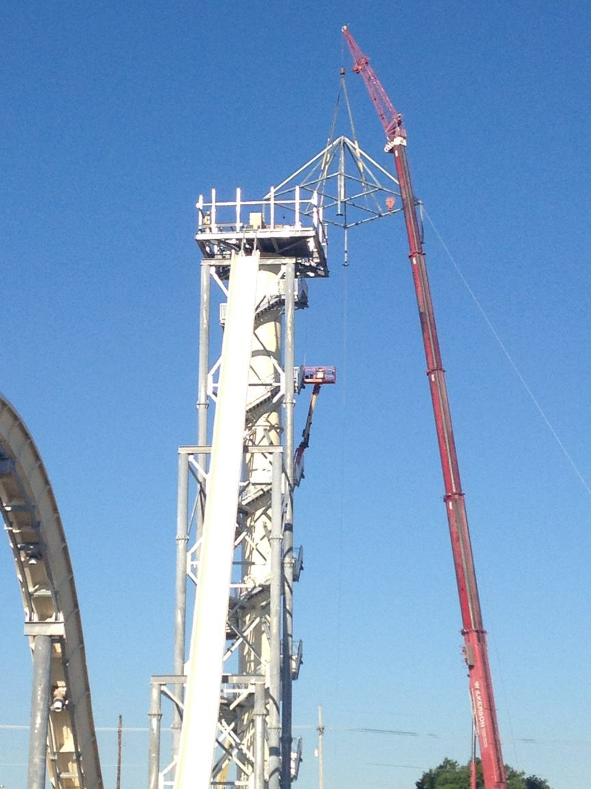 The construction crew reaches another milestone when it places the platform on top.