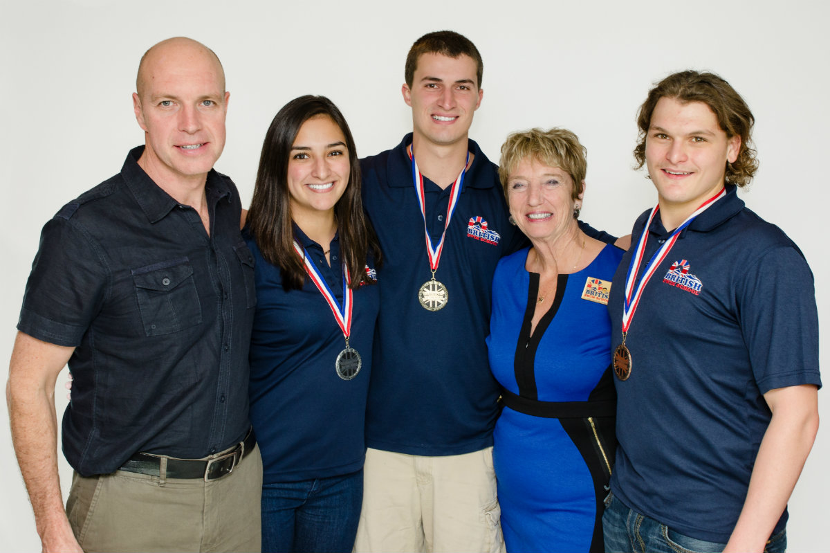 British Swim School founder Rita Goldberg (second from right) poses with the franchise's 'Instructors of the Year' along with UK Olympic gold medalist Adrian Moorhouse (far left).