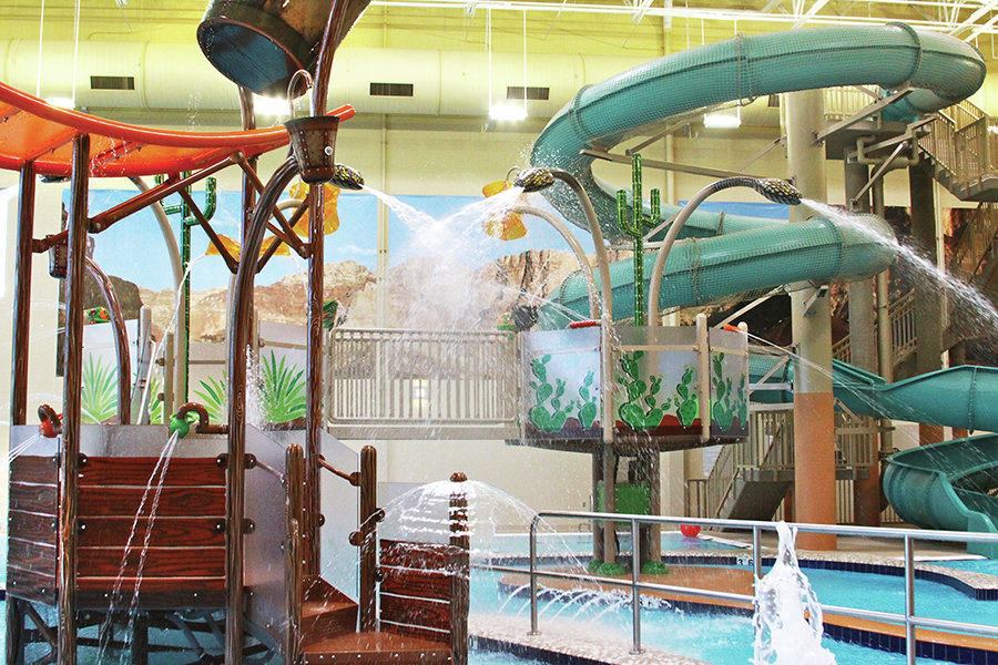 The choice of materials and theming reflect a Grand Canyon theme and recall other landscape features, flora and fauna found in the state. Murals of the landmark set the scene, along with desert colors in hues bright enough to engage children – those of red rock, bright oranges, sage greens, yellows and beiges. Cactus and agave images are used at the edges of the play structure, while netting material surrounding the waterslide mimics the scales of a desert snake. 