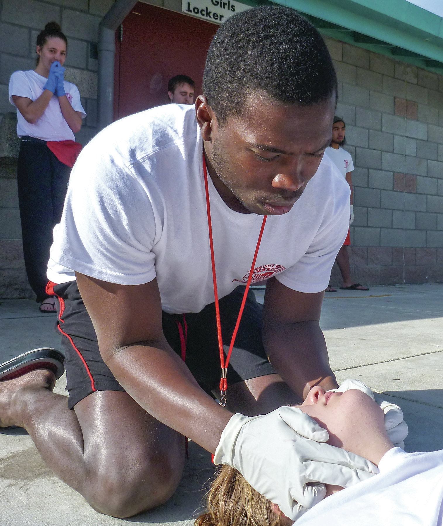 Rescuers in Action: When checking for breathing and pulse in the cephalic position, remember to continue to look down the victim's chest.