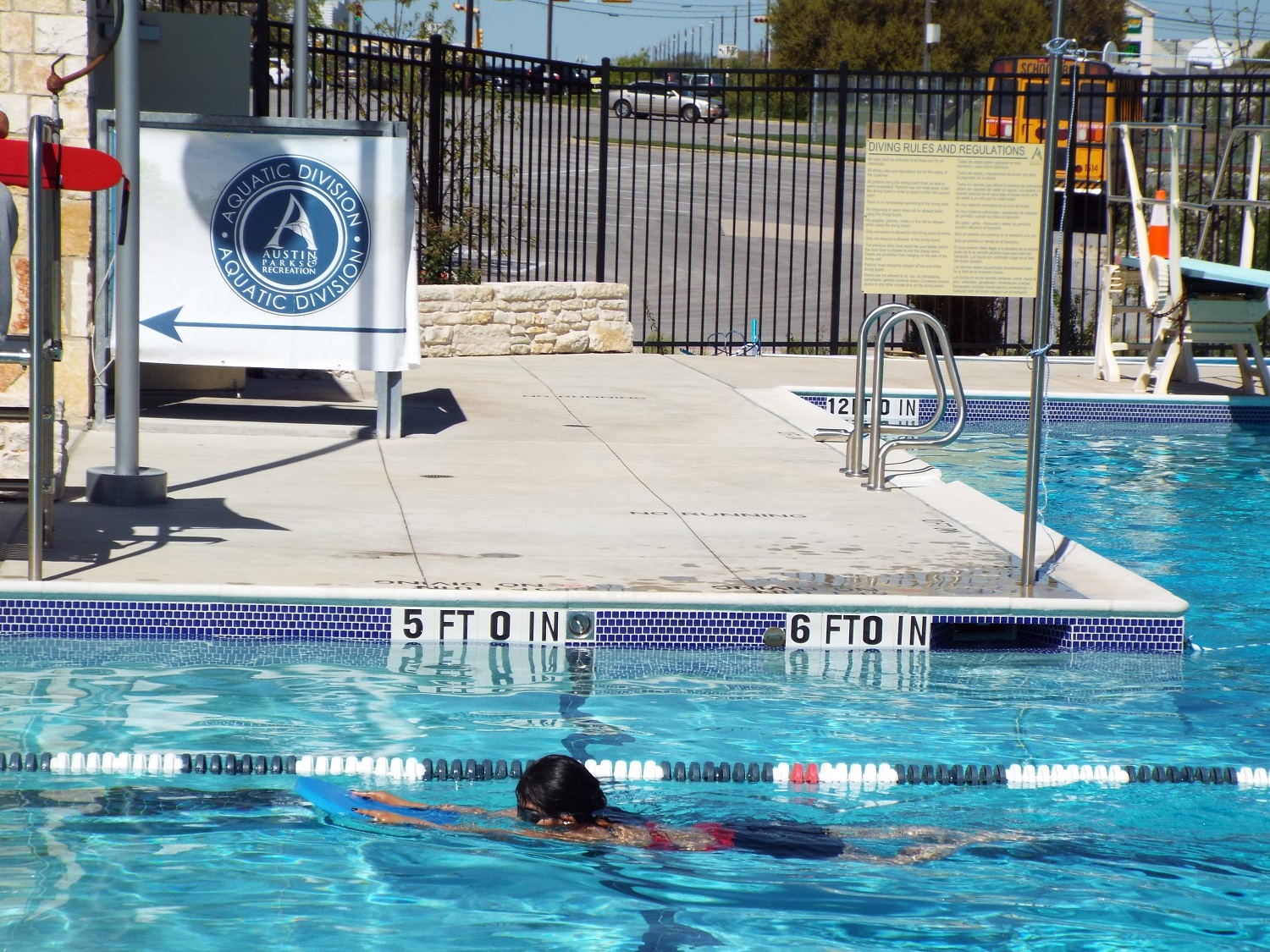 Notice the school bus in the background? In addition to covering the costs of the course and providing goggles and swimwear, SwimATX arranges for schools to deliver students to city pools during school hours. 