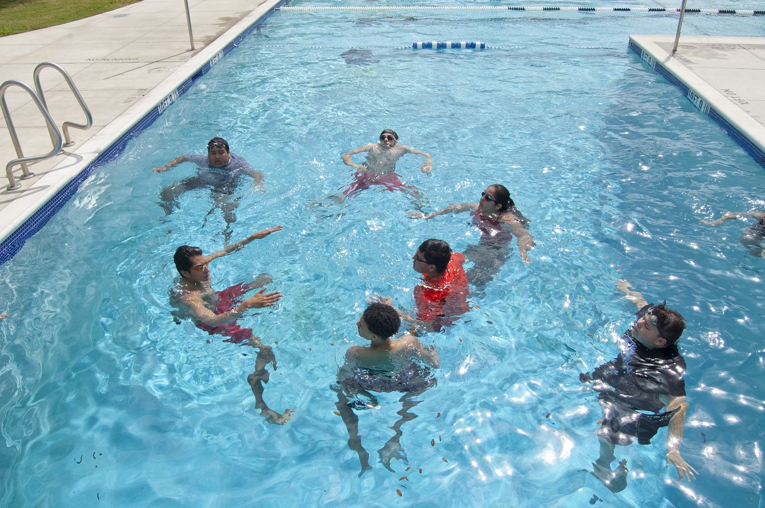 An instructor goes over the fundamentals of swimming with students at Lyndon B. Johnson Early College High School in Austin. Students generally come into the course with very limited water skills. 