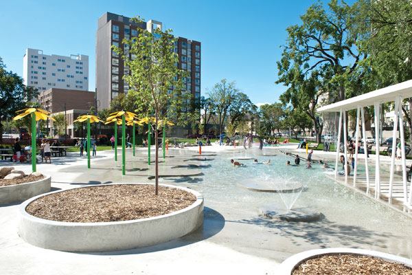 Along with the wading pool,

which features concrete islands, ground spray features, a waterfall

and a UV system to help maintain water quality, amenities at

Central Park include an interactive water table with troughs for

water-manipulated play, a unique dry playground and an embedded

artificial turf soccer field. Amenities were added as part of a

plan to revitalize a historic park that had become rundown and

potentially dangerous. Now, the park is the pride of the

predominantly immigrant community it serves.