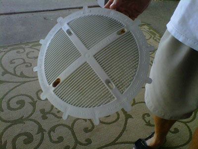 Hardware questions: Industry observers note the rust stains on two of the holes on the Drainsafe DS 360 drain cover, pictured here, saying it may indicate that non-compliant screws were used.