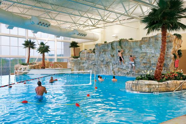 The most noteworthy feature of the leisure pool is a one-of-a-kind realistic bouldering wall with a variety of climbing holds for all levels of expertise.Southeast Missouri State’s 40-foot-wide-by-14-foot-high wall allows users to climb and fall into the 7-foot-deep leisure pool.

Taking four weeks to complete, it was formed upon dozens of concrete fabricated panels mounted on a steel cage. All rock features were cast in place, using forms based on real rocks, and the result is a wall that looks and feels like real rock, providing as close to a real-life climbing experience as possible. The leisure pool also includes water basketball and volleyball areas, a rope swing, a “bubble-bench” overlooking windows framing the pool’s vanishing edge, and a zip line.